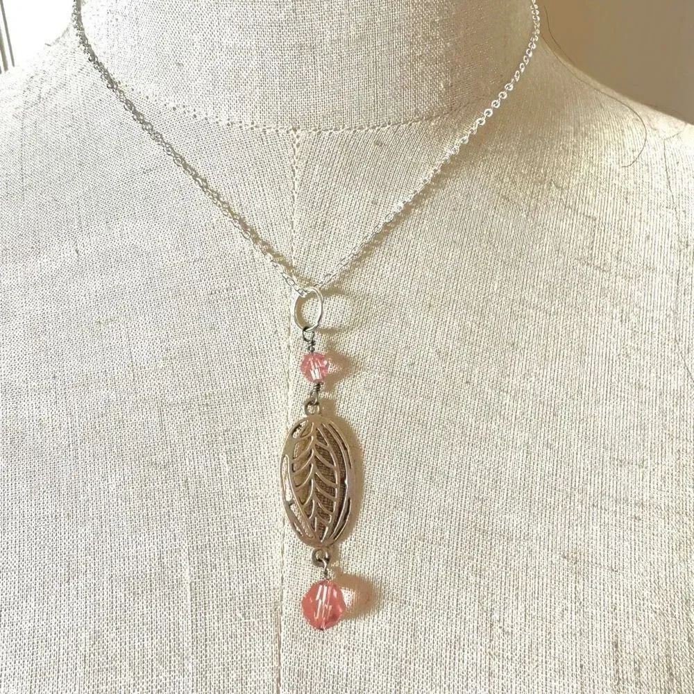 Silver tone and pink pendant necklace